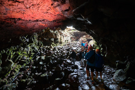 一群游客探索劳法希尔火山洞穴自然固化形成的岩浆图片