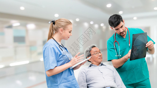 男医生与另一名医务人员一起检查病人的x光片图片