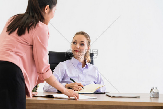 商人在办公室与同行业女商人探讨图片