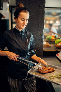 女厨师持有新鲜准备的牛排烤肉排烹饪厨房食品图片