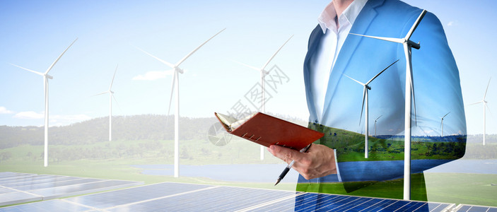 在风力涡轮机农场和绿色可再生能源工人界面上作的商人士双重接触图像图片