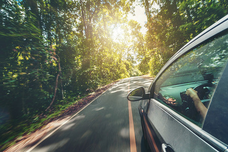 夏季在森林高速公路上驾驶黑色汽车旅行和探索图片
