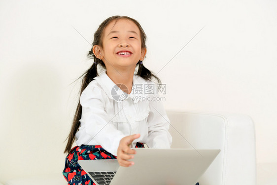 小女孩高兴的抱着笔记本电脑玩图片
