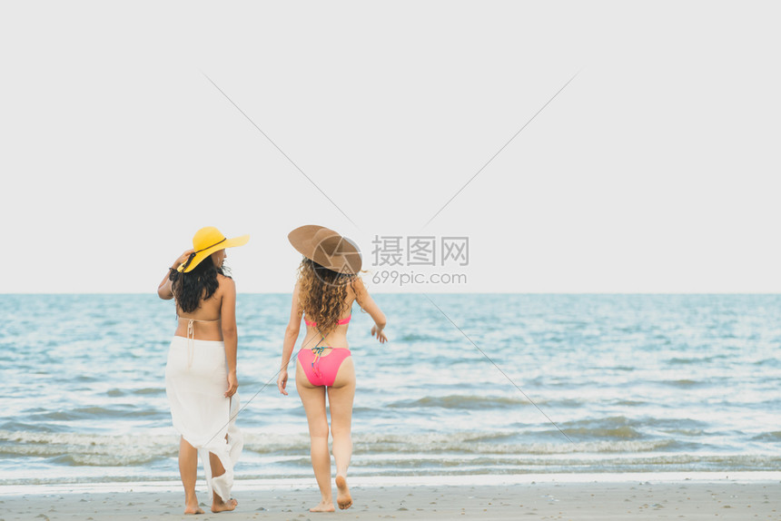 快乐的女在夏天去沙滩晒太阳图片