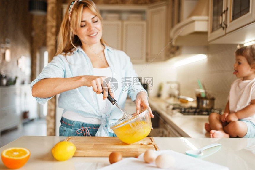 快乐的女人在打鸡蛋做糕点图片