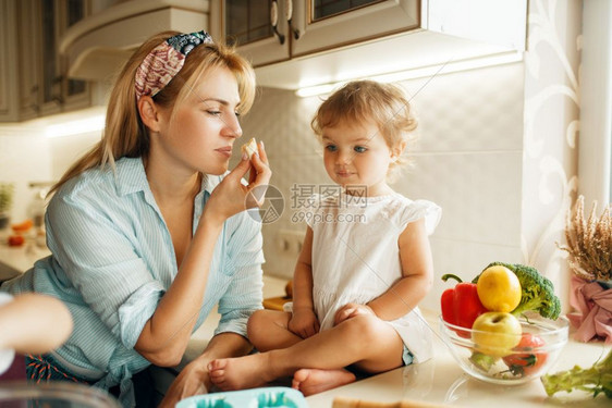 女人和小孩在厨房做饭吃蛋糕幸福的家庭吃甜点图片