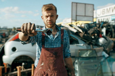 汽车垃圾场废料场的男修理员图片