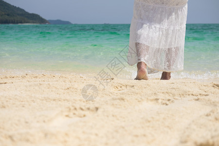一个美丽的无忧虑女人在海滩上放松享受她的阳光穿着自由服装图片