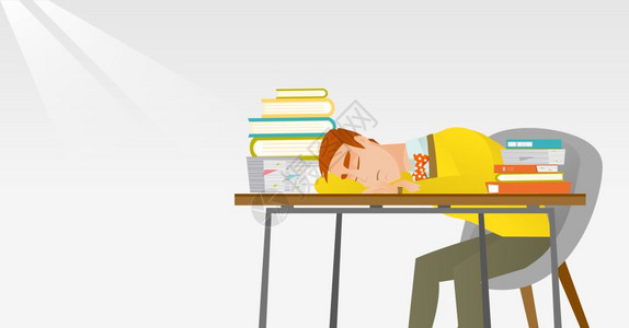 疲倦的学生睡在书桌上图片