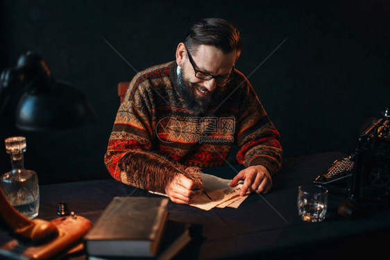倒写打字机晶除尘器书和桌上的旧灯戴眼镜的留胡子作家用羽毛写图片