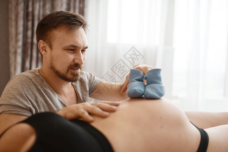 孕期产前父亲为新生儿做衣服图片
