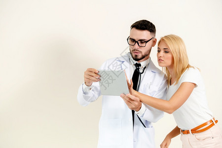 男医生和女病人看平板电脑以获取保健数据记录图片