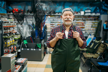 渔夫在场钩子和baules上试穿橡胶短裙背景渔场的具和捞狩猎工具从属选择渔夫在场试穿橡胶短裙渔夫在场试穿橡胶短裙图片