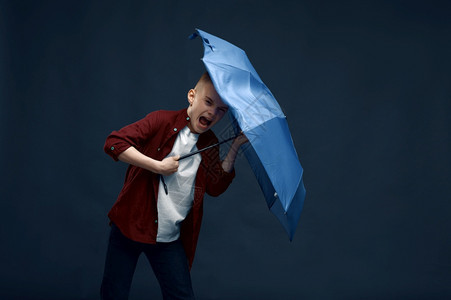 孩子们在摄影棚里拿着雨伞拍摄图片