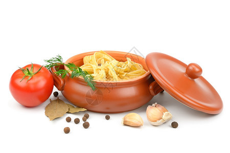 含有意大利面蔬菜和香料的粘土锅在白色背景中被孤立图片