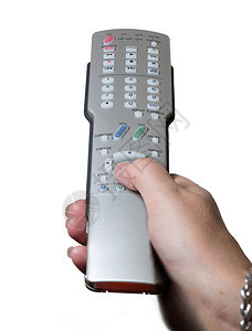 由在白色背景下被孤立的拇指按下现代银色TV遥控器图片