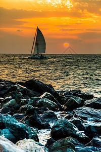 游艇海上日落时的浪漫旅行图片