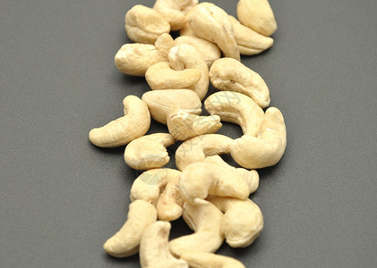 腰果杏仁胡桃荚干燥种子高清图片食物餐巾测试面包师手上的腰果饼干