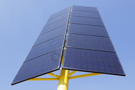黄金属板和蓝天空两方向的太阳能电池板图片