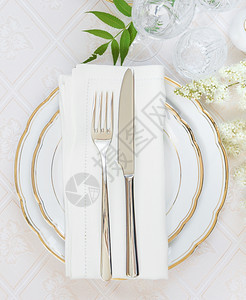 美的装饰桌顶上面有白色板晶杯水眼镜面巾餐具和白花在豪华桌布上有文字空间图片