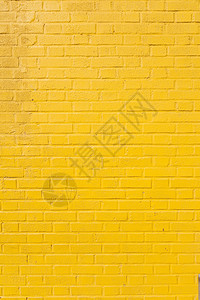 亮黄色油漆砖块墙的垂直部分图片