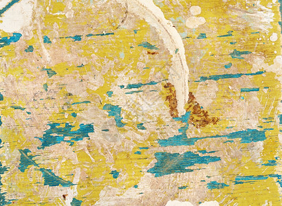 多彩背景旧木多彩表面有黄色和蓝涂料及裂缝纹理图片