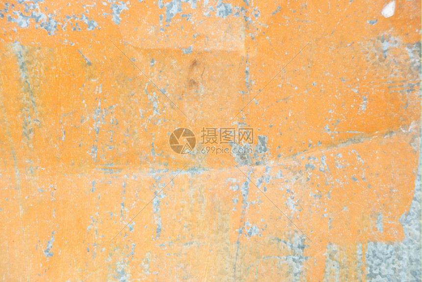 橙色背景含薄膜涂料和折合纹理的金属表面图片