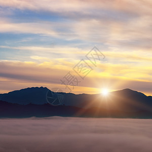 明亮的日出山谷雾地平线上山峰图片