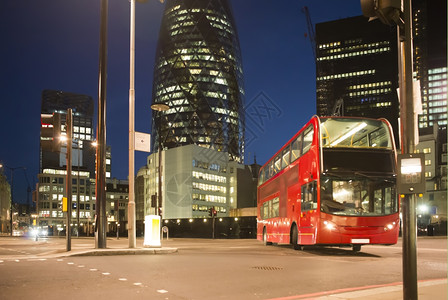 英国街道夜晚红色公共汽车在隆登市运行背景