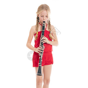 红色的年轻女孩在白色背景下玩单簧管图片