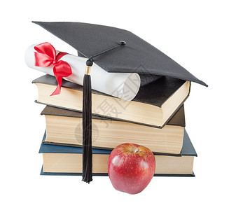 教育概念黑色毕业帽子大书红苹果和纸卷用红丝带和弓子捆绑在白色背景上孤立图片