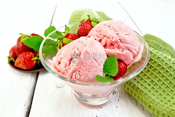 杯子里的冰淇淋草莓和薄荷浅木板底的餐巾纸图片