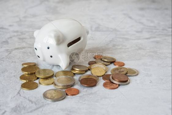 财政失败的概念白瓷皮小猪库身旁被金属硬币包围图片