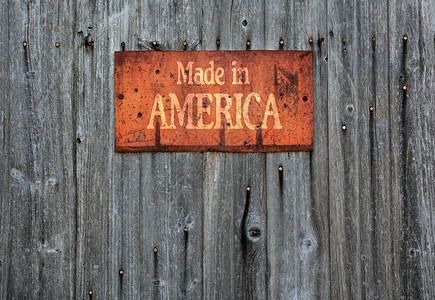 木制墙上的铁锈标志面写着用美国制造的图片