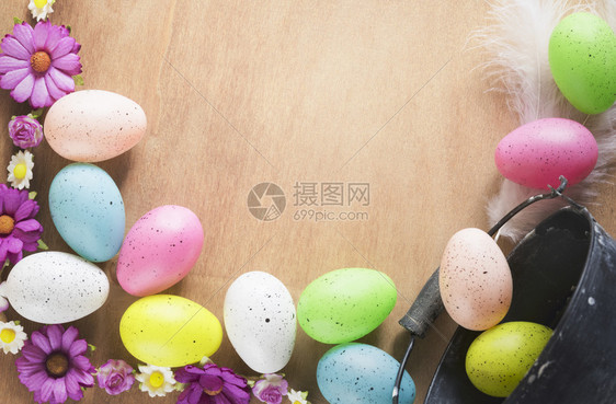 木桌上布满了鲜花和彩色鸡蛋图片