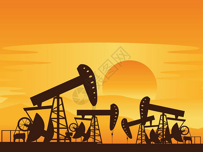日落时油泵背景和工作油泵的轮廓图片