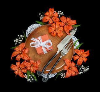 装有橙丽花白带丝的礼品盒和黑色背景与世隔绝的专用伪造餐具顶楼平面图片