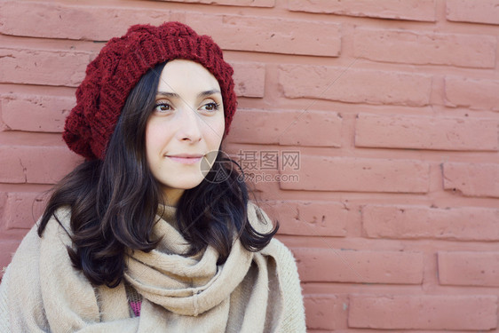 年轻女子的冬天肖像与砖墙对着女士穿时尚的冬天服装图片