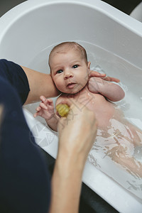 妈妈抱着浴缸里的新生儿图片