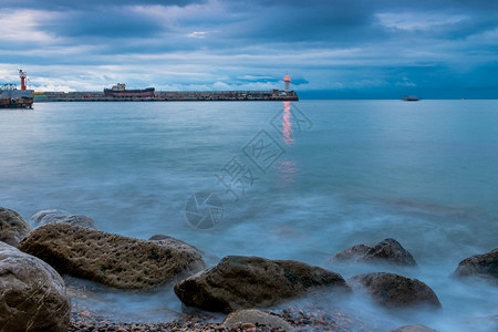 黄昏海边的灯塔风景海上有雨云图片