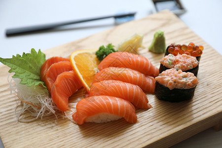 鲑鱼寿司和木板上的生鱼肉图片
