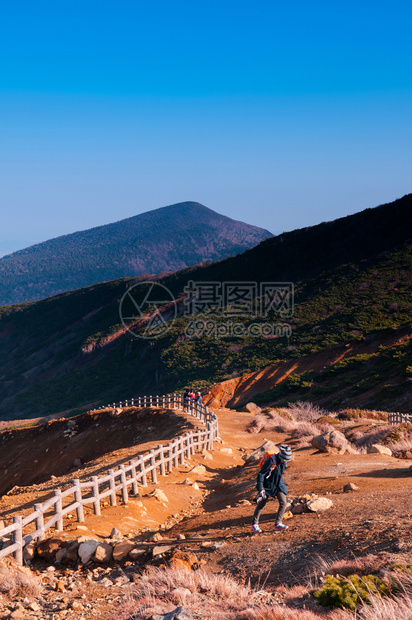 旅游者正在山顶上行走图片