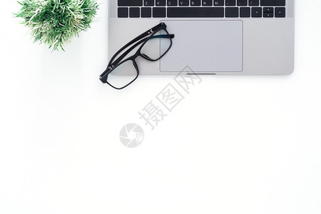 书桌上的眼镜与笔记本电脑图片