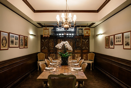 2014年3月7日2014年BangkoThailnd内地古老的房子内有旧的木质晚餐桌优雅的木椅古典董吊灯和装饰鸟笼图片