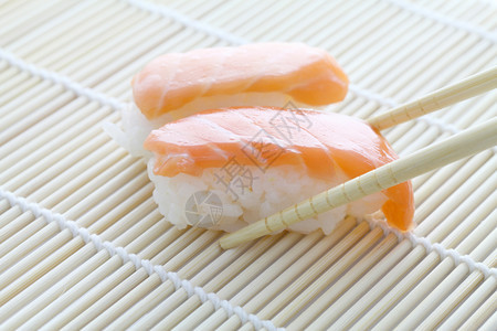长着筷子的鲑鱼寿司图片