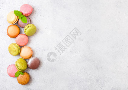 甜点蛋糕马卡龙或有薄荷叶的马卡龙放在石餐桌背景上顶部视图文本空间图片