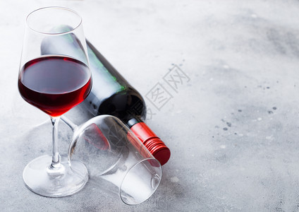 厨房餐桌背景的优雅玻璃和一瓶红酒图片