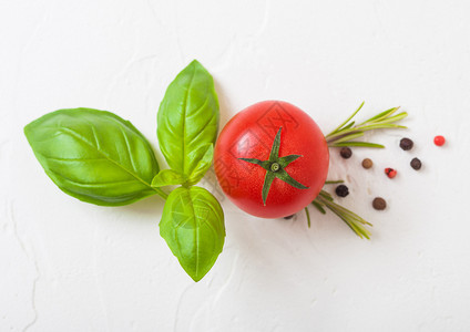 葡萄藤上的有机番茄和白厨房石头底的辣椒和图片