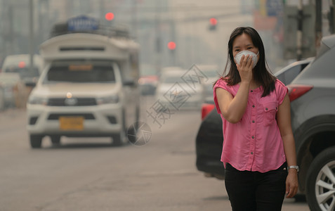 泰国清迈一名戴着防护口罩的年轻女子在城市街道上图片