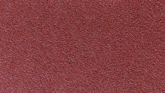 用于工业建筑概念设计工作的红色沙纸纹理背景图片